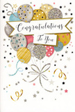 An elegant congratulations card stands upright in the image, its front decorated with a graceful composition of balloons that suggests a quiet, joyful party about to unfold in Motspur Park. The central focus is a cluster of rounded balloons drifting together in soft metallic and pastel tones-warm gold, cool silver, champagne beige, gentle blue, blush pink and muted grey. Each balloon is embellished with a slightly different design, from scattered star patterns and tiny glitter-like speckles to slim, shimmering stripes, giving the impression of various textures under the fingertips and a gentle sparkle when the card catches the light. Fine strings in gleaming gold and silver descend from the base of the balloons, curling and looping with a natural flow before gathering loosely at the lower part of the artwork, just as ribbon ends from a festive bouquet might fall onto a table near West Barnes Lane. Across the middle of the balloon cluster, a bright white banner sits proudly, bearing the words "Congratulations To You" in flowing, calligraphic script that feels both warm and sincere. Around this focal point, small metallic stars, dots and swirling ribbon motifs scatter across a pale, subtly textured background, echoing the look of confetti and streamers suspended at the peak of a celebration. The overall mood is uplifting yet gently refined, perfectly suited to marking milestones like promotions, exam successes or new beginnings. When placed beside a vase of fresh flowers delivered across Motspur Park, New Malden or the surrounding neighbourhoods, this card becomes part of a complete gesture of appreciation and pride, capturing the essence of a heartfelt "well done" in a single, beautifully balanced image.