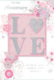 This anniversary card appears as a gentle, paper tribute to enduring love, blending pastel hues and fine detail with the grace of a hand-tied bouquet. At its centre, the word "LOVE" is spelled in raised letters dusted with soft, shimmering glitter, the tones of blush pink merging subtly with silvery highlights. The letter "O" is subtly suggested as a heart shape, edged in sparkling silver that stands out against the powder-pink background. That background glows with a velvety softness, evoking the cosy interiors of Motspur Park homes on a special evening. Surrounding the central word, clusters of delicate blossoms in blush, mauve, and creamy ivory open gently, their petals painted with a watercolour-like softness. Each flower and leaf is defined by fine, flowing lines that curve like the stems and tendrils in a romantic bouquet, reminiscent of designs crafted by Motspur Park Florist for local anniversaries. Tiny flourishes-whirling swirls, scattered petals, and nearly-hidden butterflies-thread through the design, adding a sense of quiet movement, as though a breeze had passed along West Barnes Lane. The phrases "On Our Anniversary" and "I love you today and always" are rendered in an understated, elegant script, their grey ink complementing rather than competing with the artwork. The typography and illustration together create an atmosphere of intimate celebration, more whisper than shout, yet deeply heartfelt. Visually, the card feels like a keepsake meant to accompany fresh roses, lisianthus, or fragrant stocks, ready for local delivery across Motspur Park and neighbouring streets to honour the shared journey of two hearts.